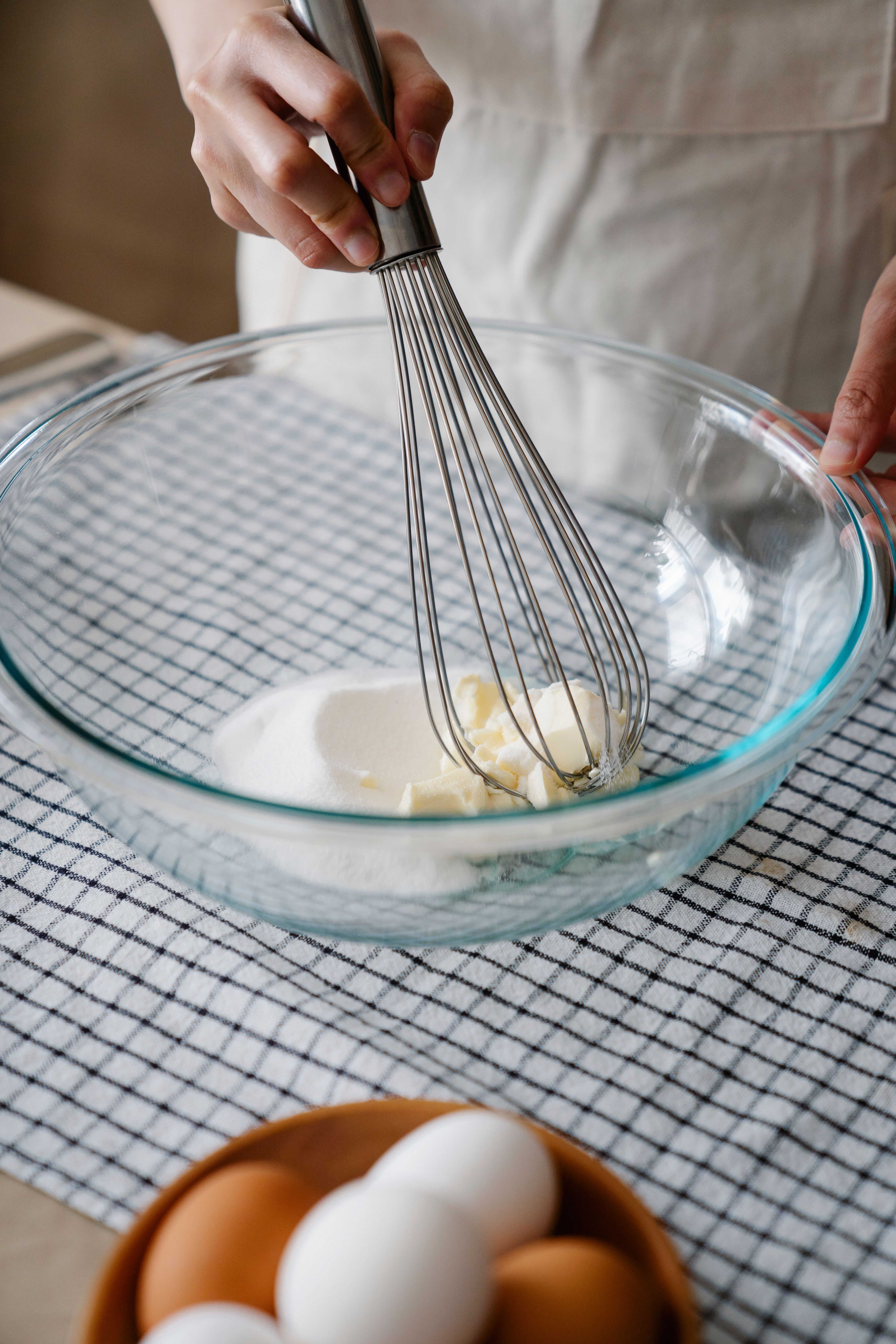 Whisking butter and sugar in a glass mixing bowl